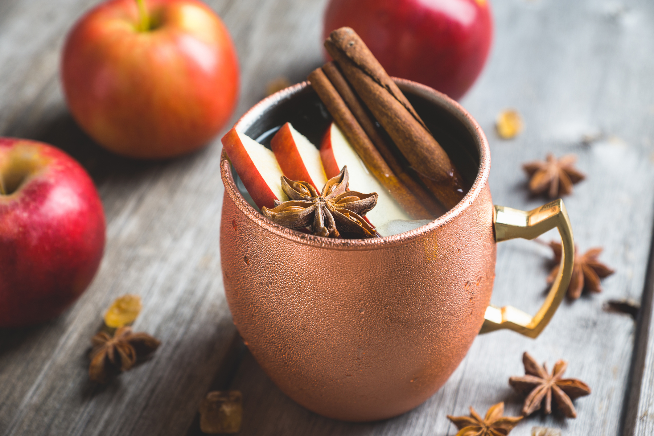 Cold Moscow Mule cocktail in copper mug on the rustic background. Shallow depth of field.