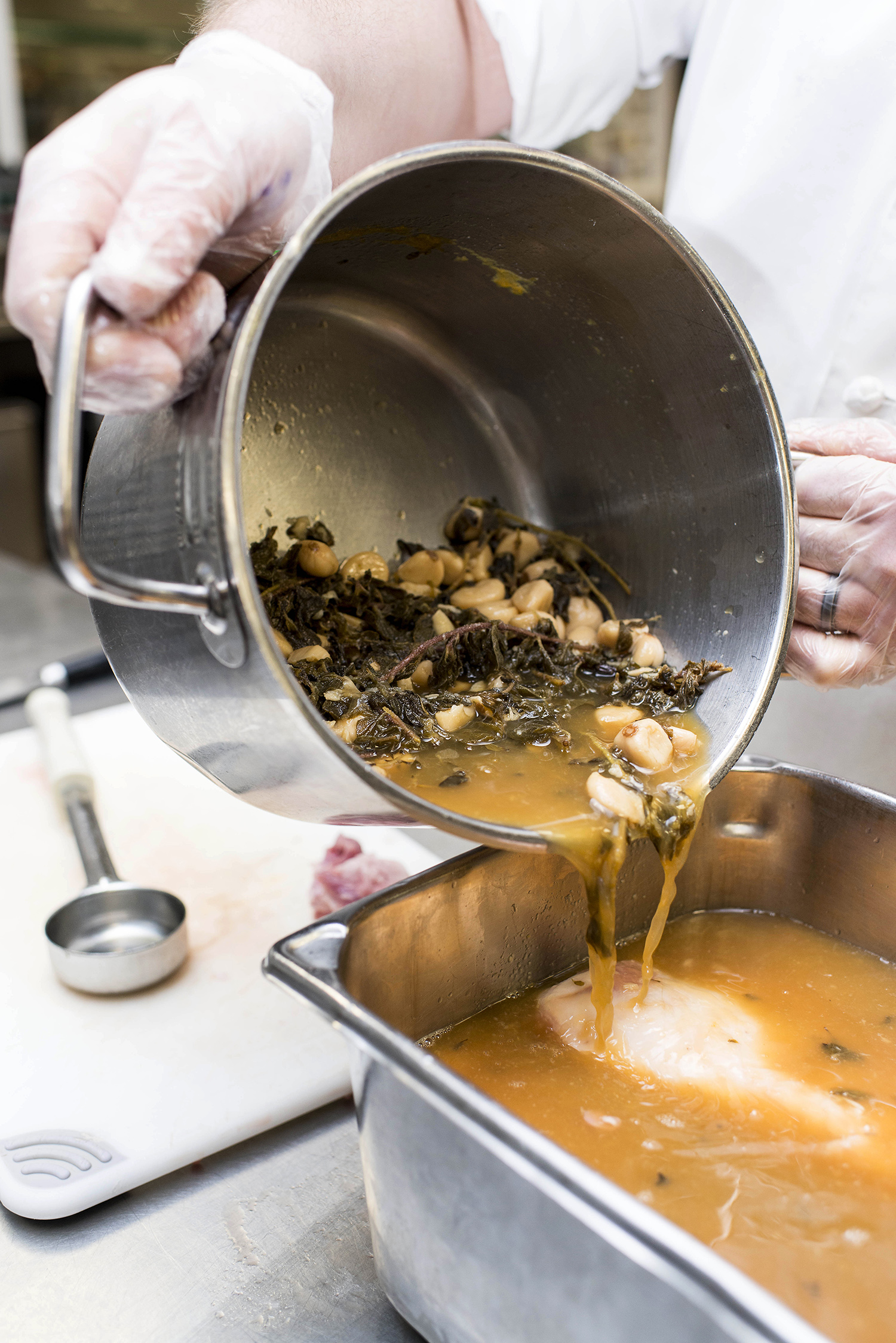 Marinating porkloin in the kitchen at Rex Hospital.