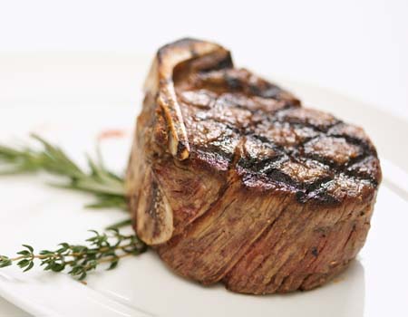 Grilled beef tenderloin on plate.