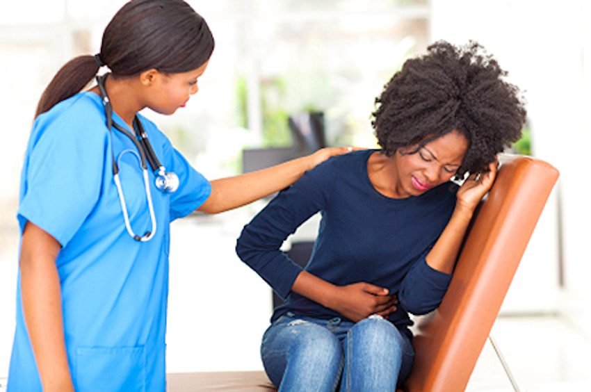 young african nurse comforting female patient