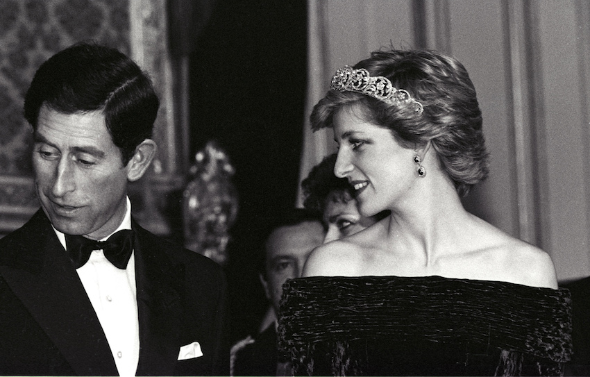 PRINCESS OF WALES LOOKS TOWARDS HUSBAND CHARLES AT BANQUET AT AJUDA PALACE IN LISBON.