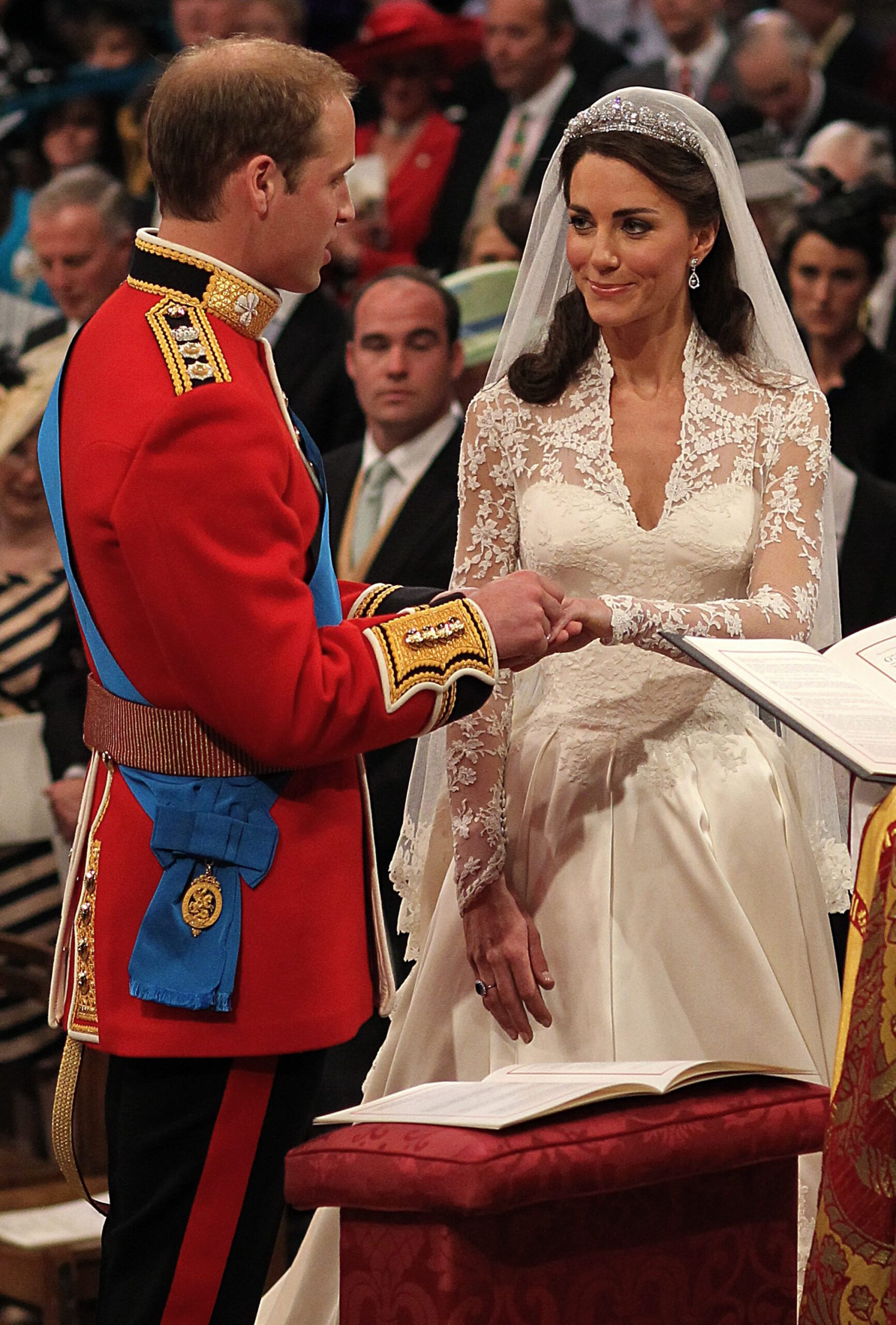 Britain's Prince William, and Kate Middleton exchange rings before the Archbishop of Canterbury, Rowan Williams, during their wedding ceremony In Westminster Abbey, in central London