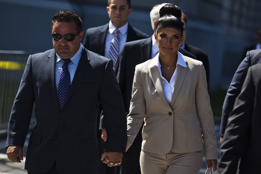 Teresa Giudice and her husband Giuseppe "Joe" Giudice hold hands as they leave the federal court in Newark, New Jersey