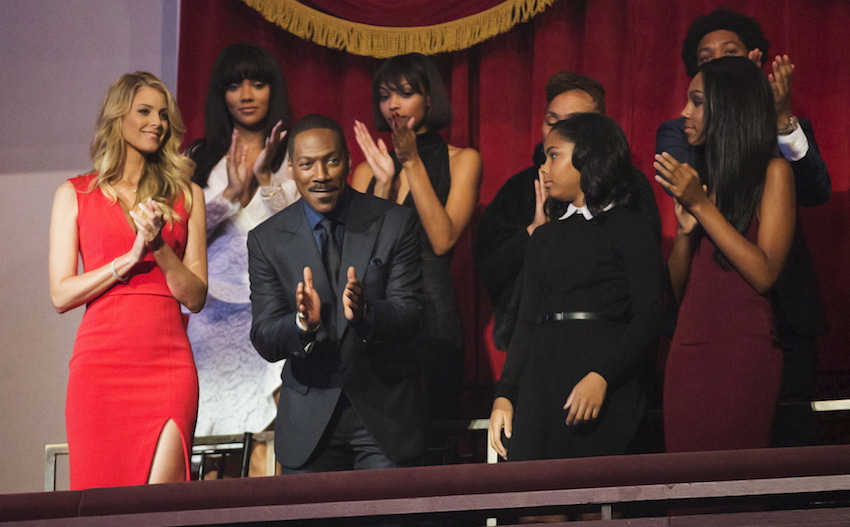 Eddie Murphy, his partner Paige Butcher and members of his family applaud as he takes his seat for the Mark Twain prize for Humor honoring him at the Kennedy Center in Washington