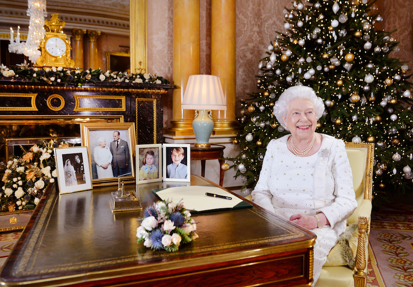 Britain's Queen Elizabeth is seen sitting at a desk in the 1844 Room after recording her Christmas Day broadcast to the Commonwealth, in Buckingham Palace, in this undated photograph received in London