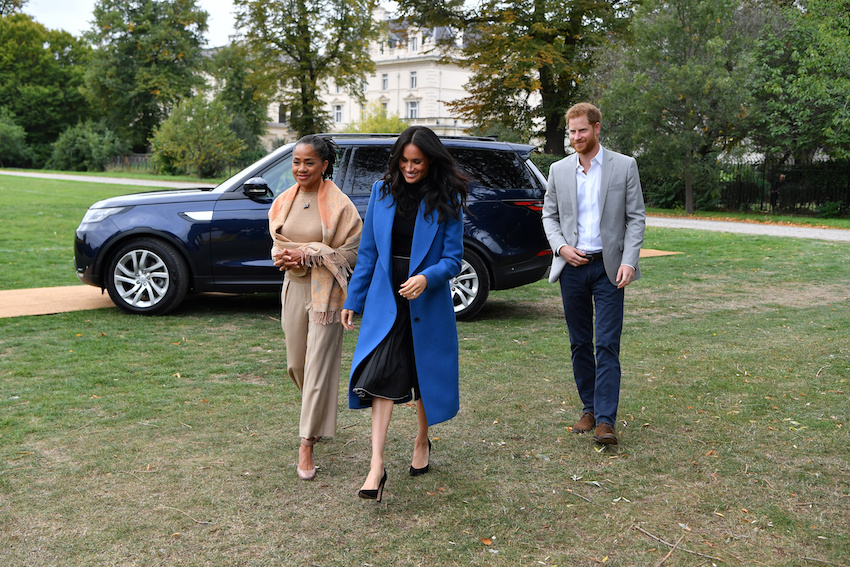 Meghan, Duchess of Sussex arrives with her mother, Doria Ragland and Britain's Prince Harry, Duke of Sussex to host an event to mark the launch of a cookbook with recipes from a group of women affected by the Grenfell Tower fire at Kensington Palace