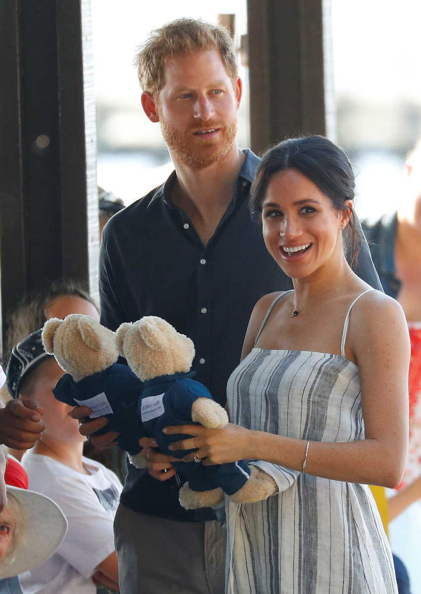 Britain's Prince Harry and Meghan, Duchess of Sussex, receive teddy bears as they greet members of the public in Kingfisher Bay on Fraser Island in Queensland