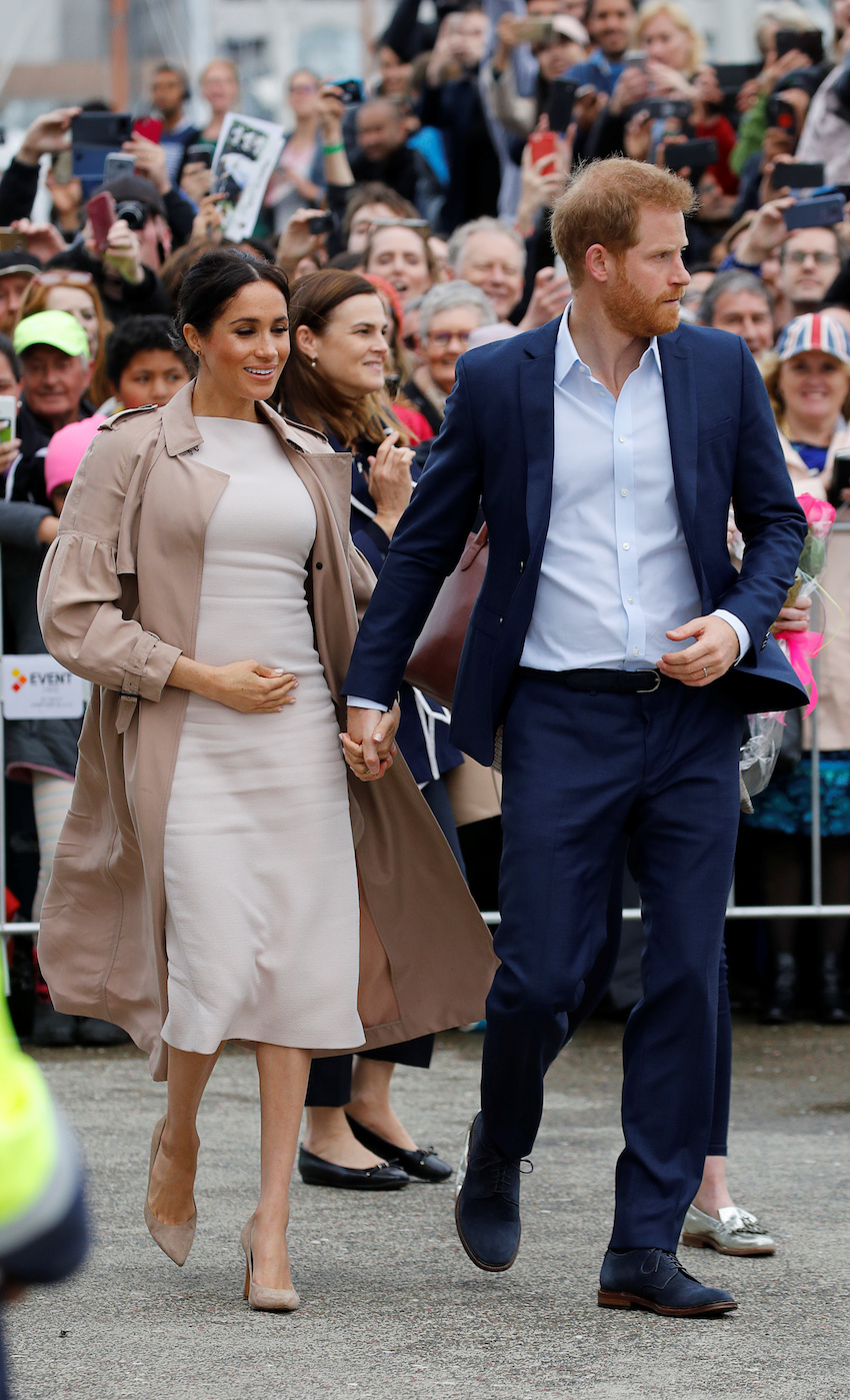 Britain's Prince Harry and Meghan, Duchess of Sussex, greet people at Viaduct Harbour in Auckland