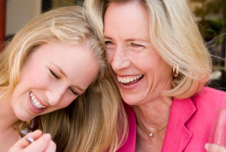 Close-up of mature woman laughing with her daughter