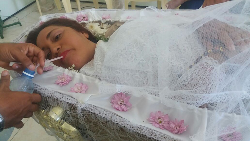 Woman holds fake funeral