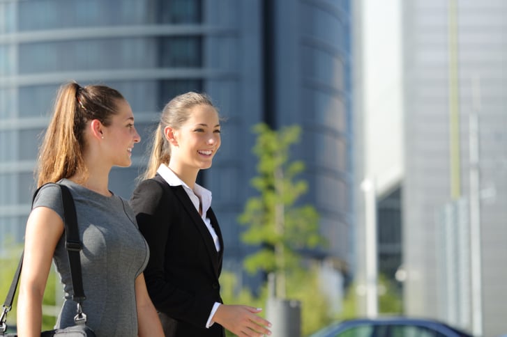 Businesswomen walking and talking in the street