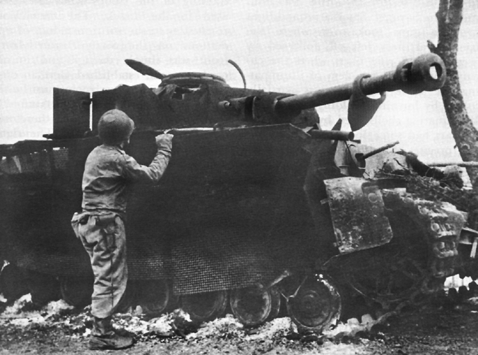 American_Soldier_Inspecting_Wrecked_German_Tank.jpg