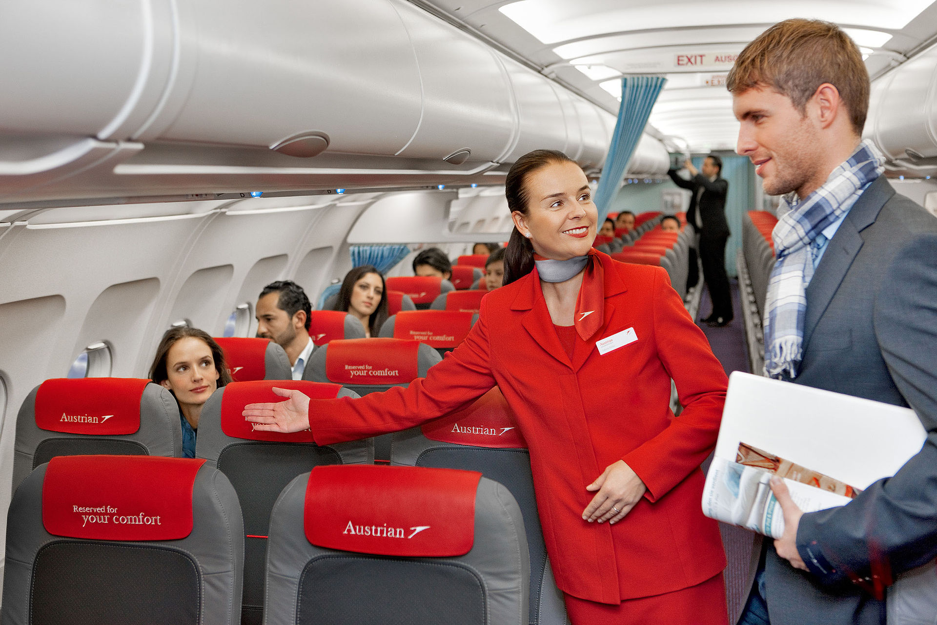 Austrian_Airlines_flight_attendant_and_passenger.jpg