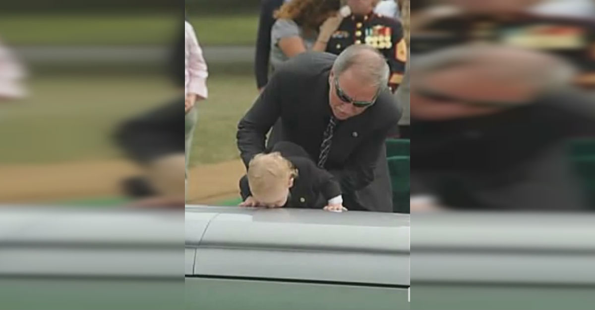 Boy Kisses Dads Grave