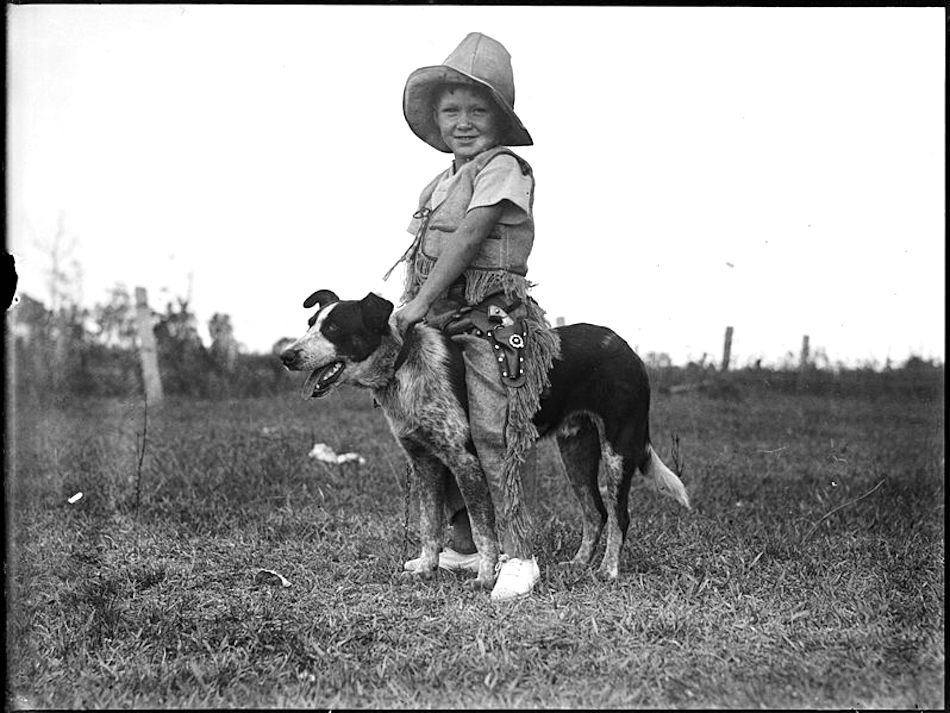 Boy_in_cowboy_suit_astride_a_dog_3551047142.jpg