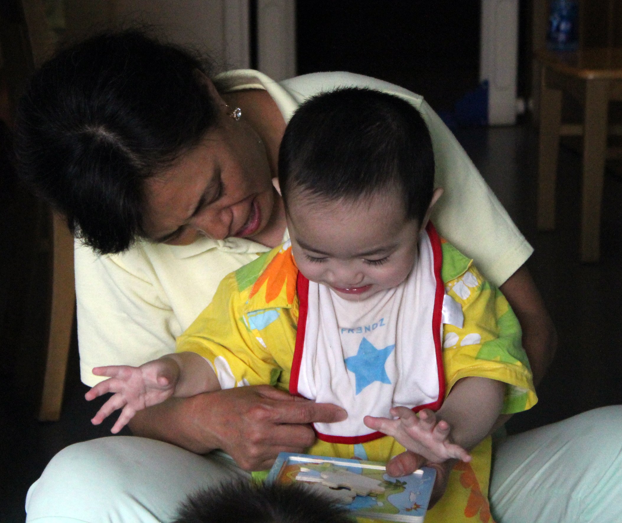 Caretaker_reads_with_child.jpg