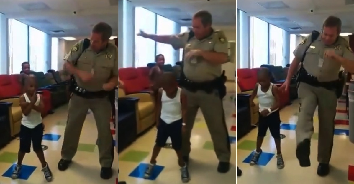 Cop Dances With Young Boy