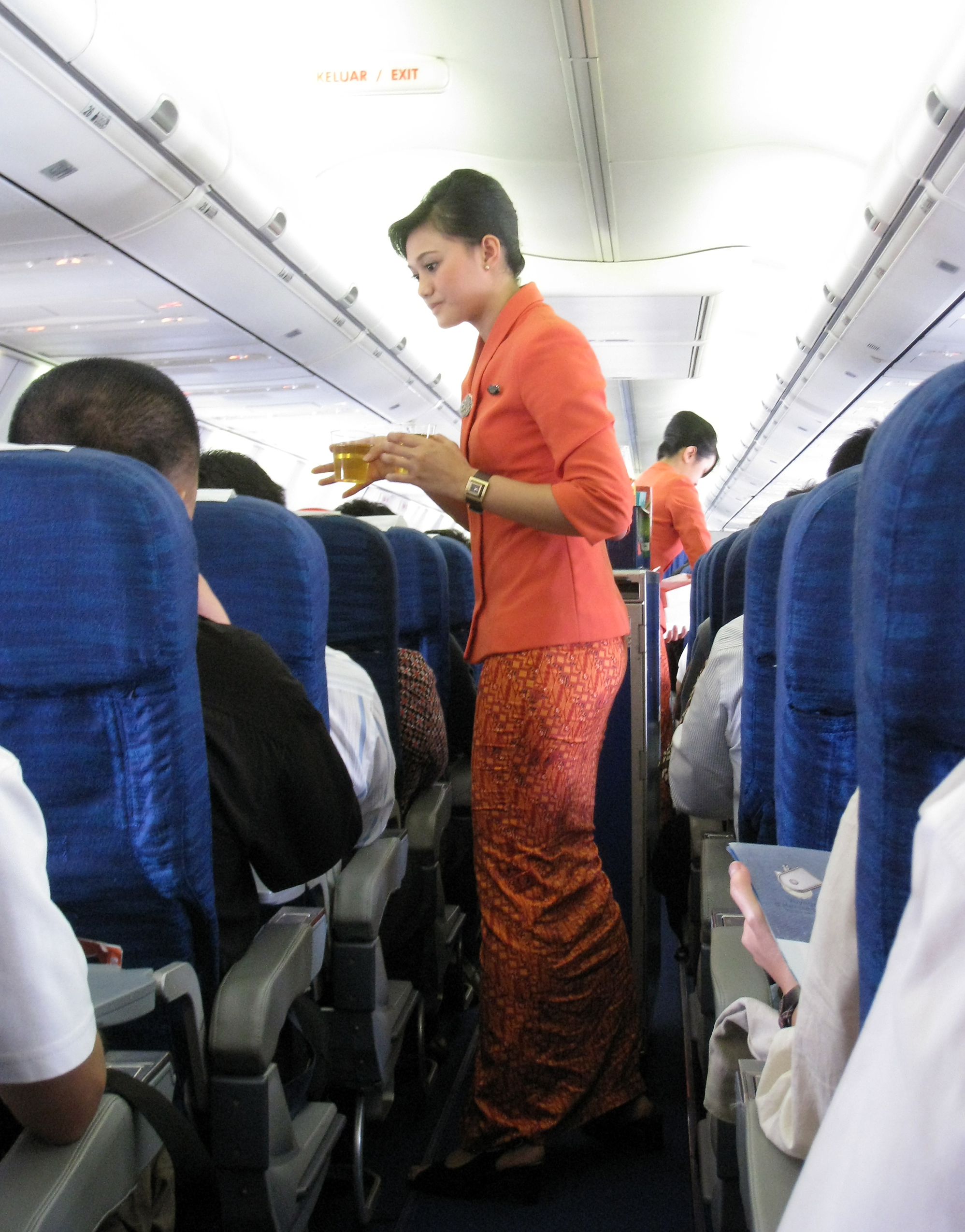 Garuda Indonesia Flight Attendants Serving Refreshment