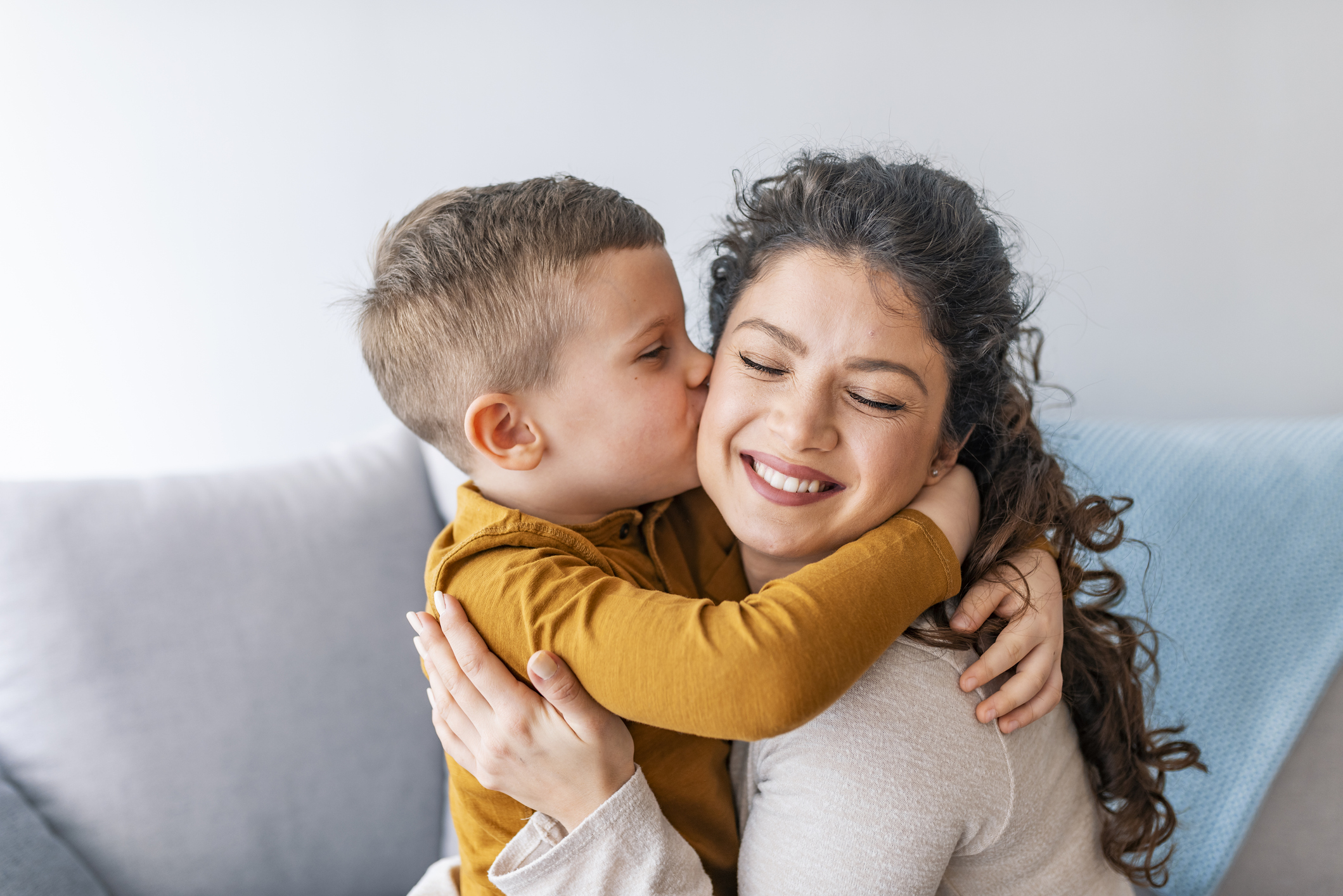 Son is kissing his mother.