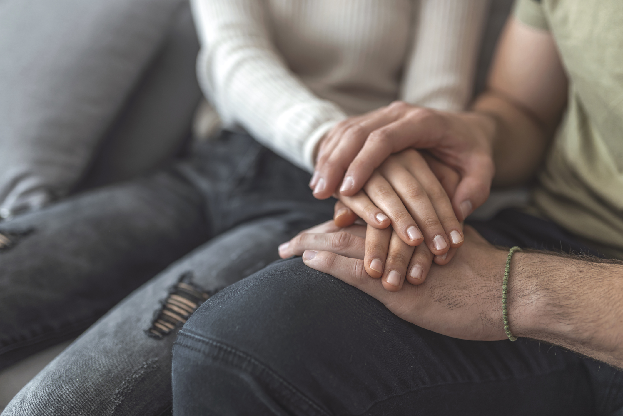 A young couple hand by hand.