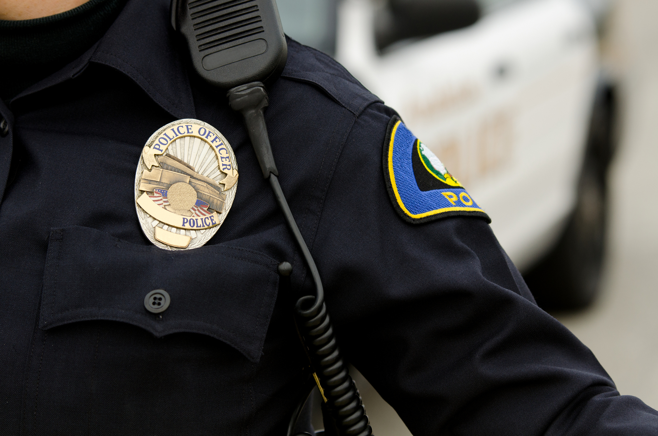 A police officer in uniform with a badge