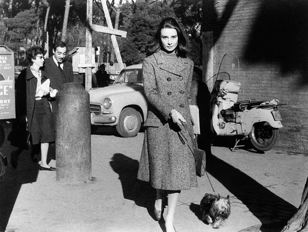 Audrey Hepburn walking with a dog