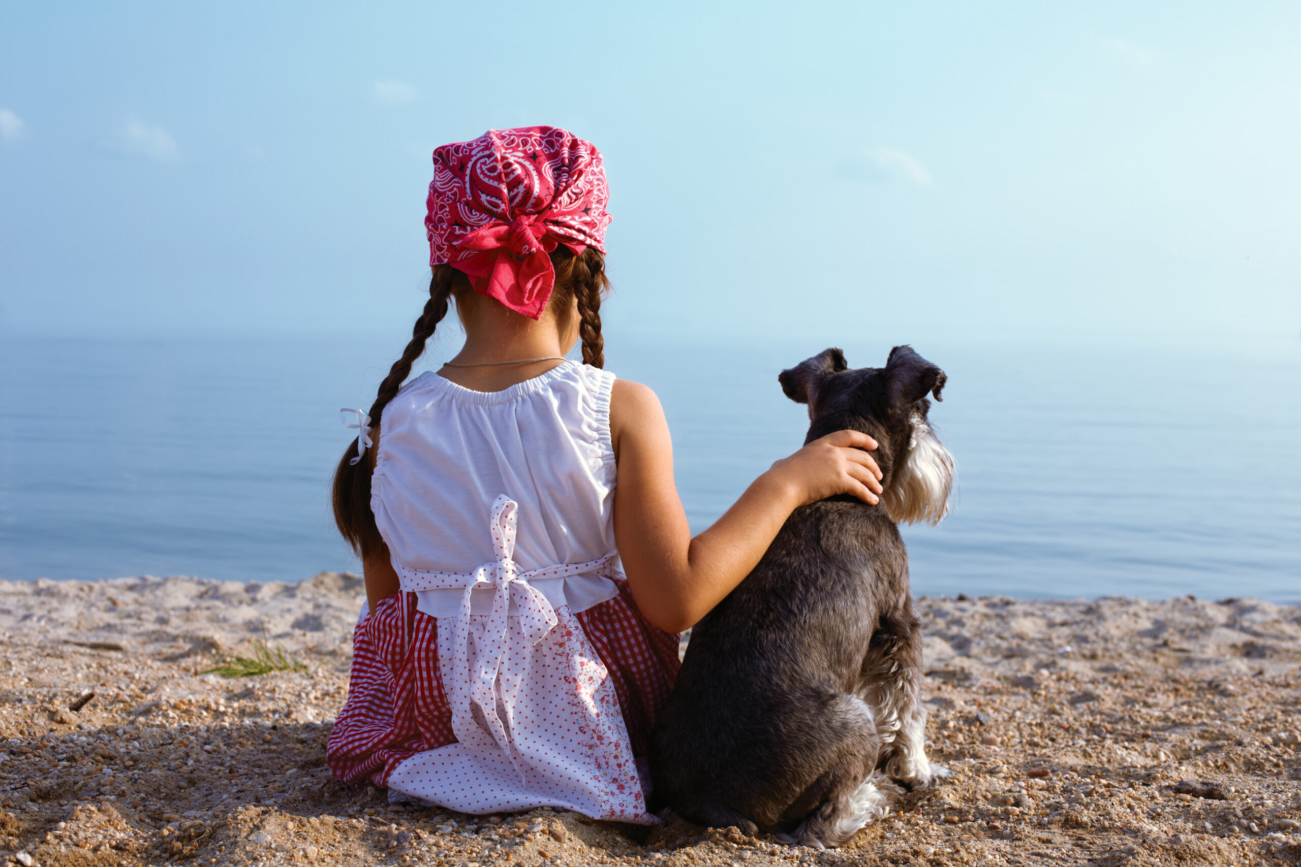 girls embracing her dog