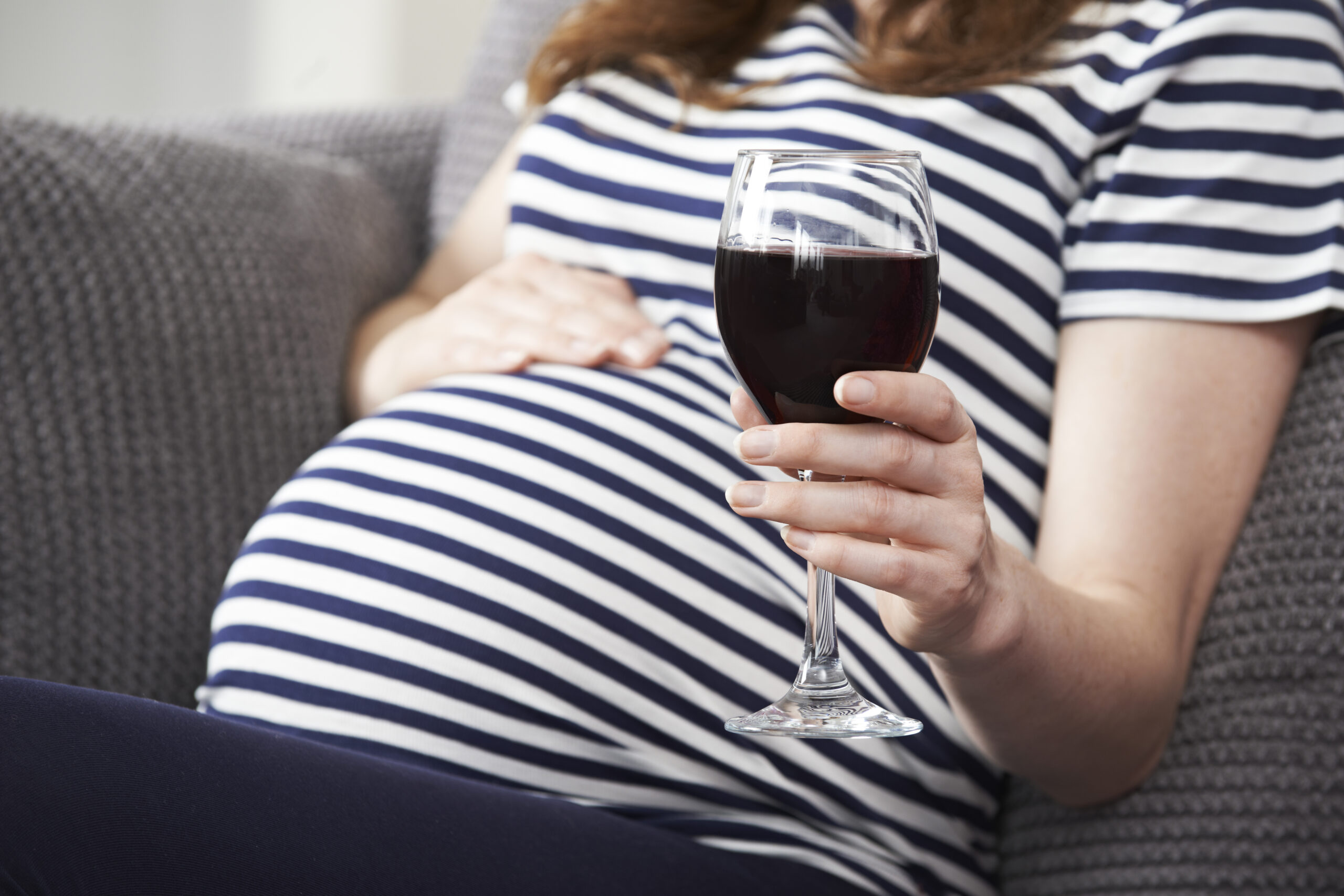 Close Up Of Pregnant Woman Drinking Red Wine