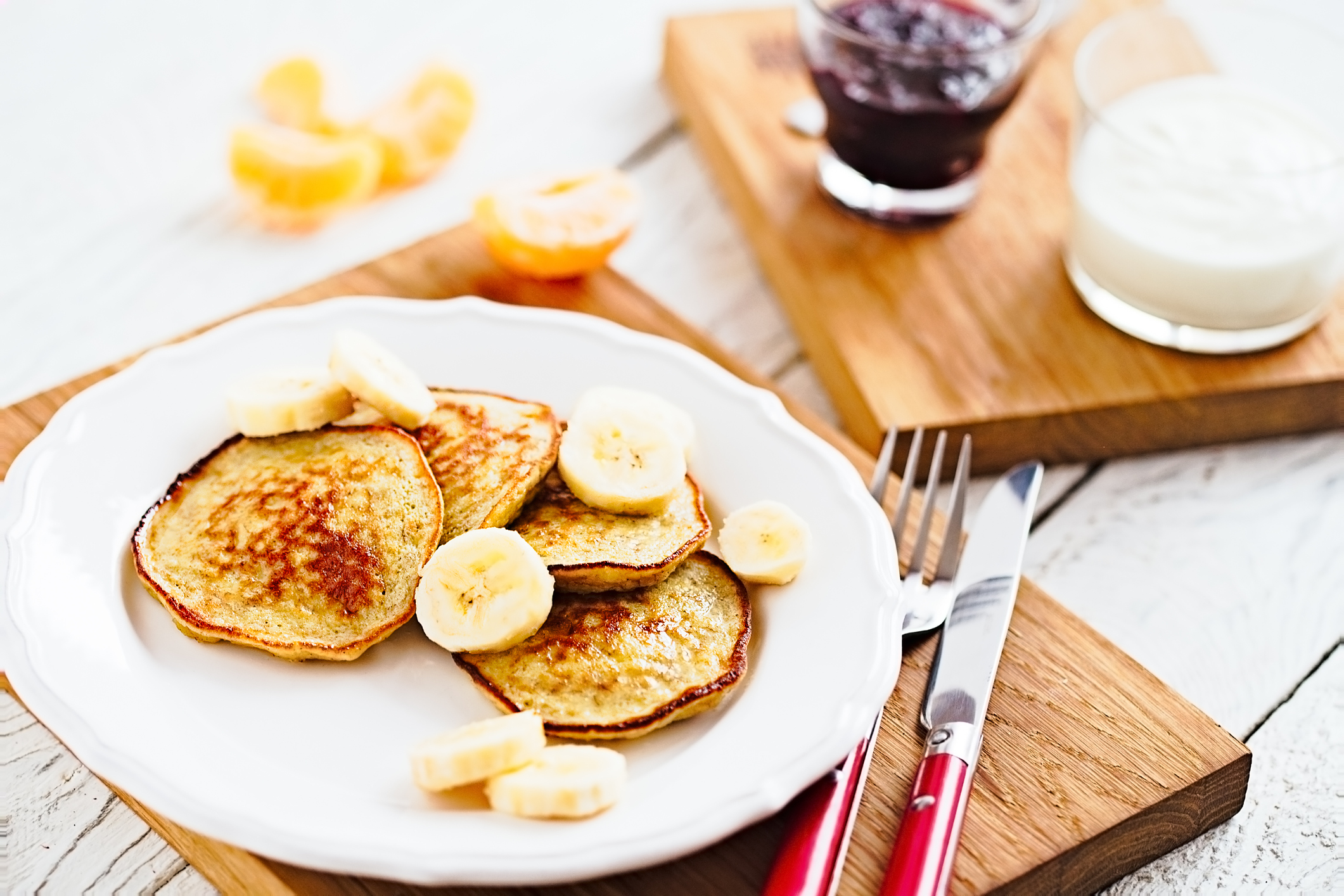 Morning banana pancakes with on white plate and wooden table