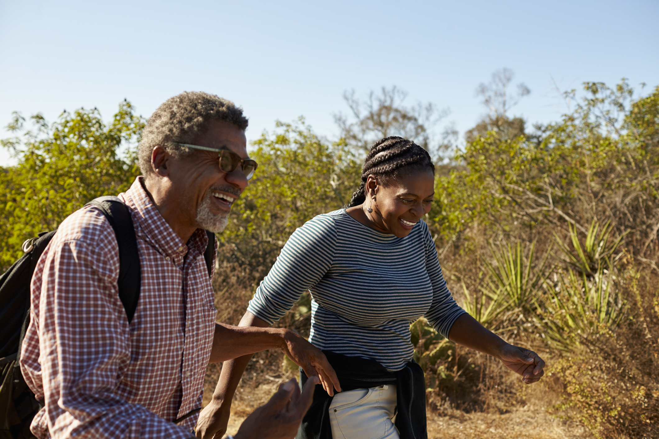 Mature Couple Hiking Outdoors In Countryside Together