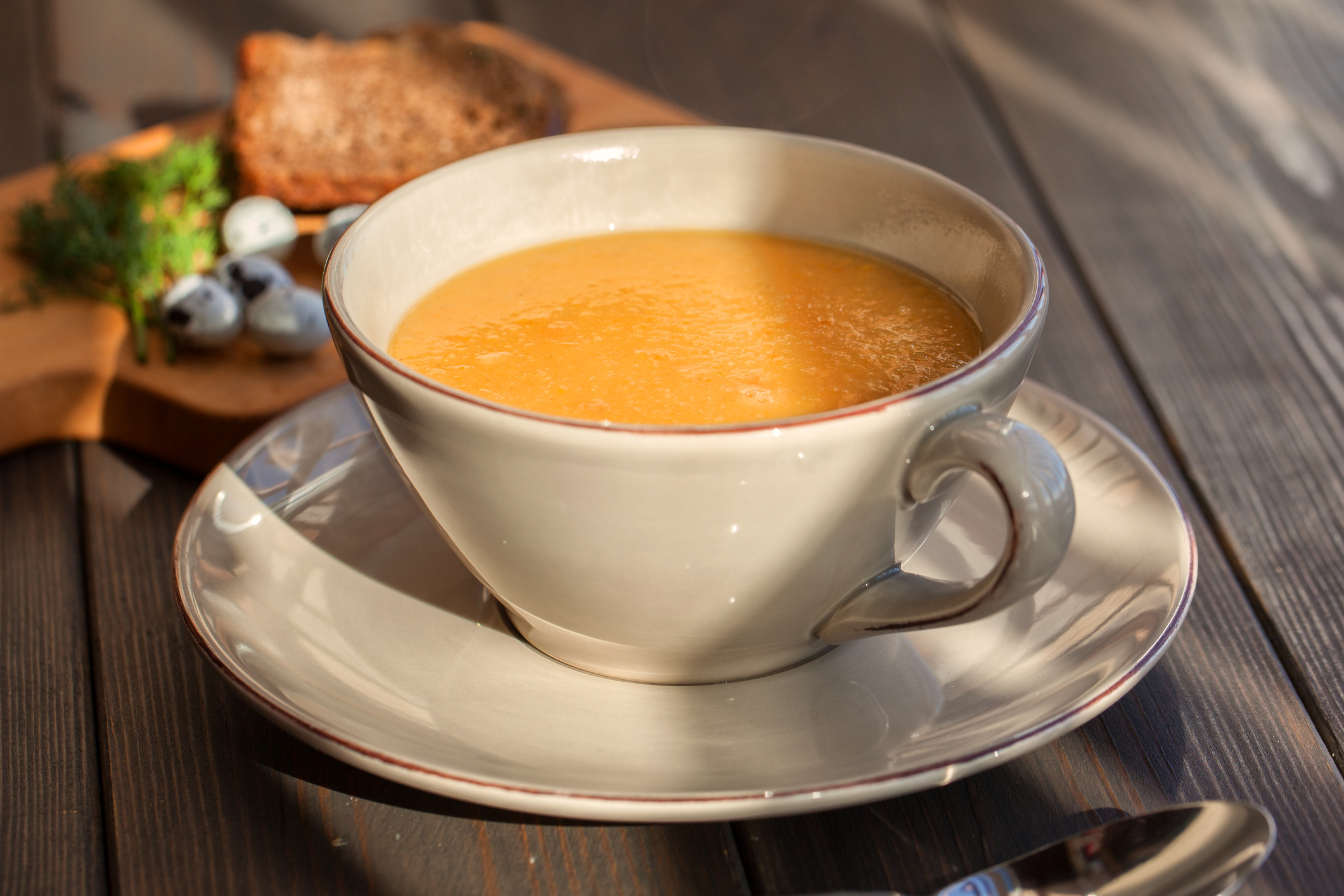 Pumpkin and lentil soup on dark wooden background. Halloween treat.