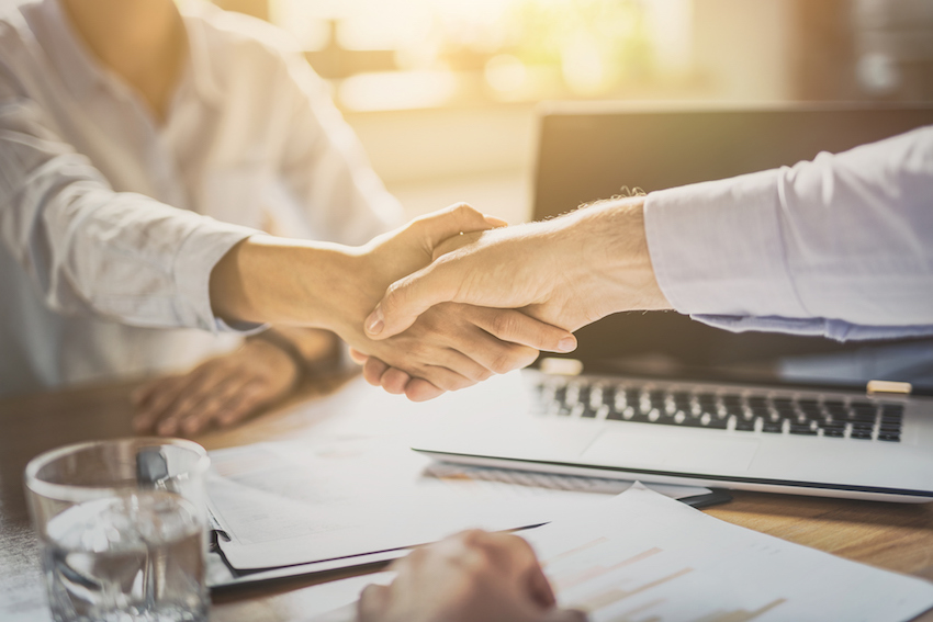 Business people shaking hands. Finishing up meeting.