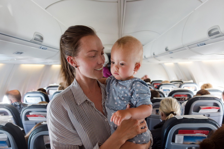 Mother and baby traveling on plane