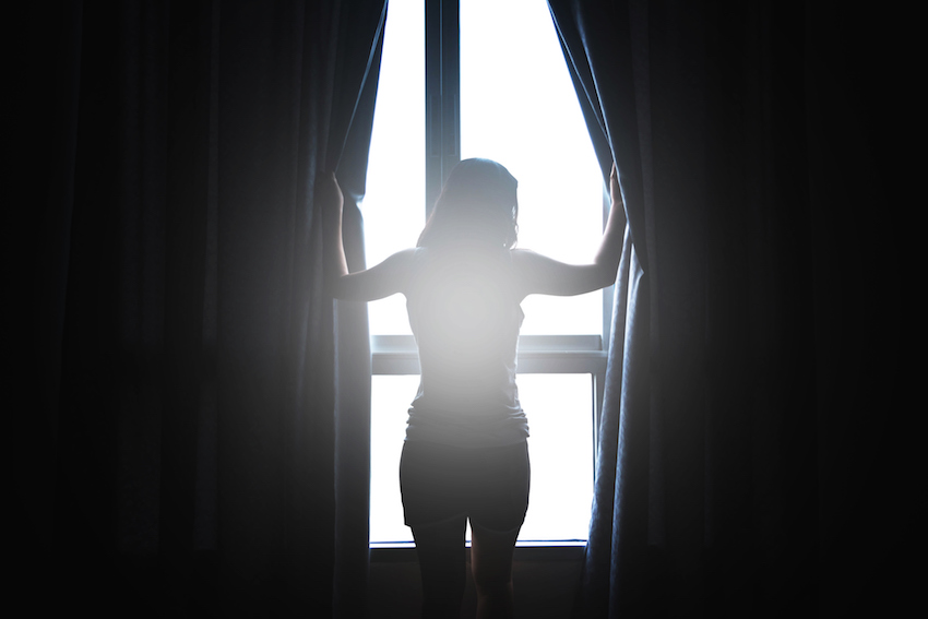 woman open window‚Äôs curtain in the morning