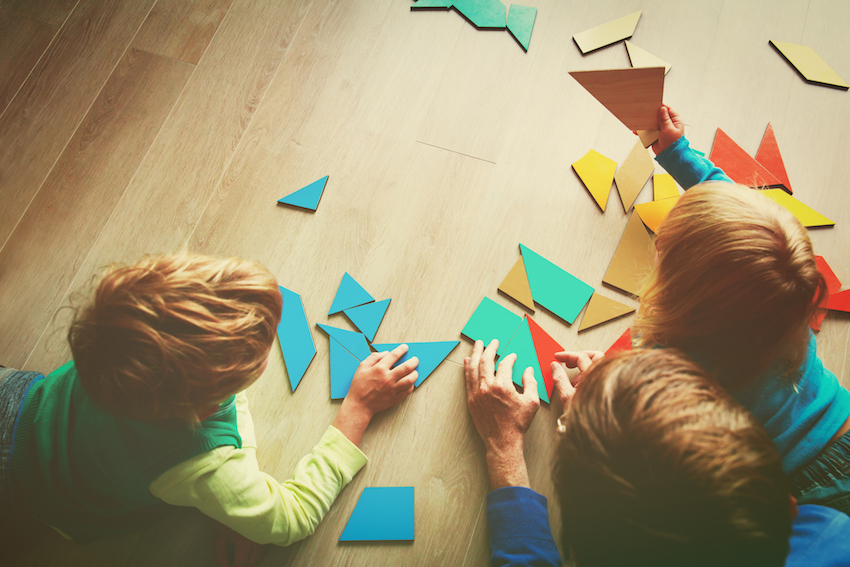 teacher and kids playing with geometric shapes