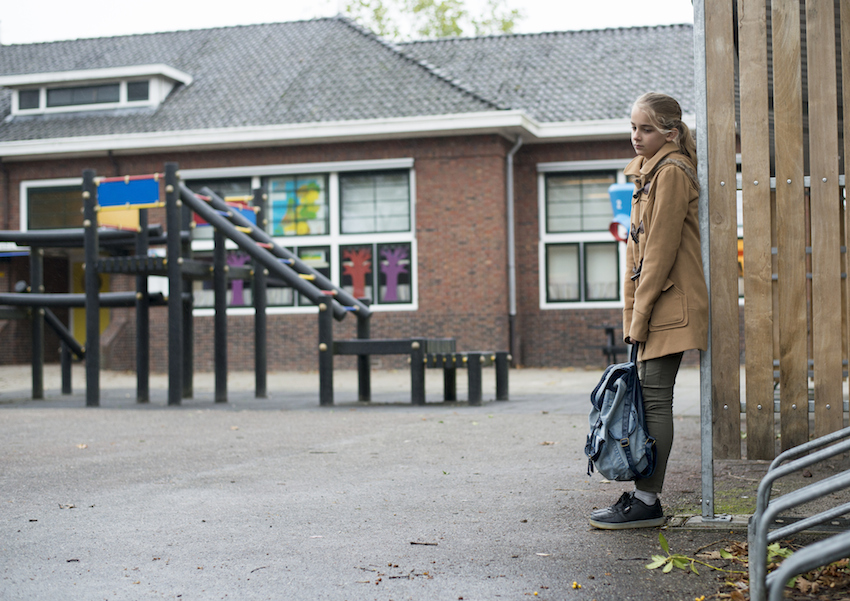 Sad girl at school yard