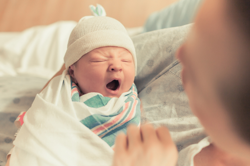 Sleepy baby yawning