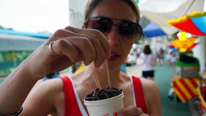 Woman eats silk worms