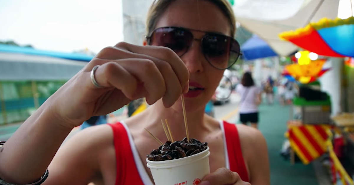 Woman eats silk worms