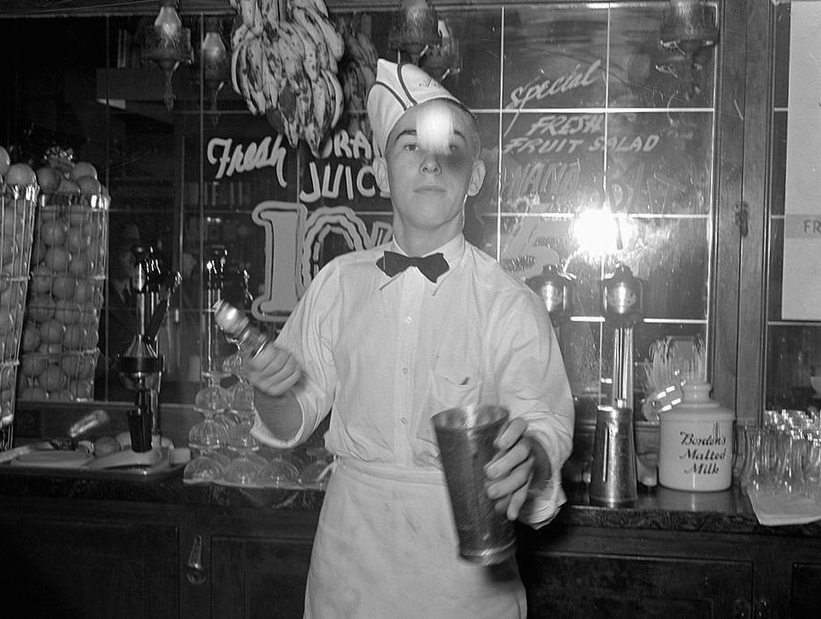 Soda_jerker_flipping_ice_cream_into_malted_milk_shakes._Corpus_Christi_Texas.jpg