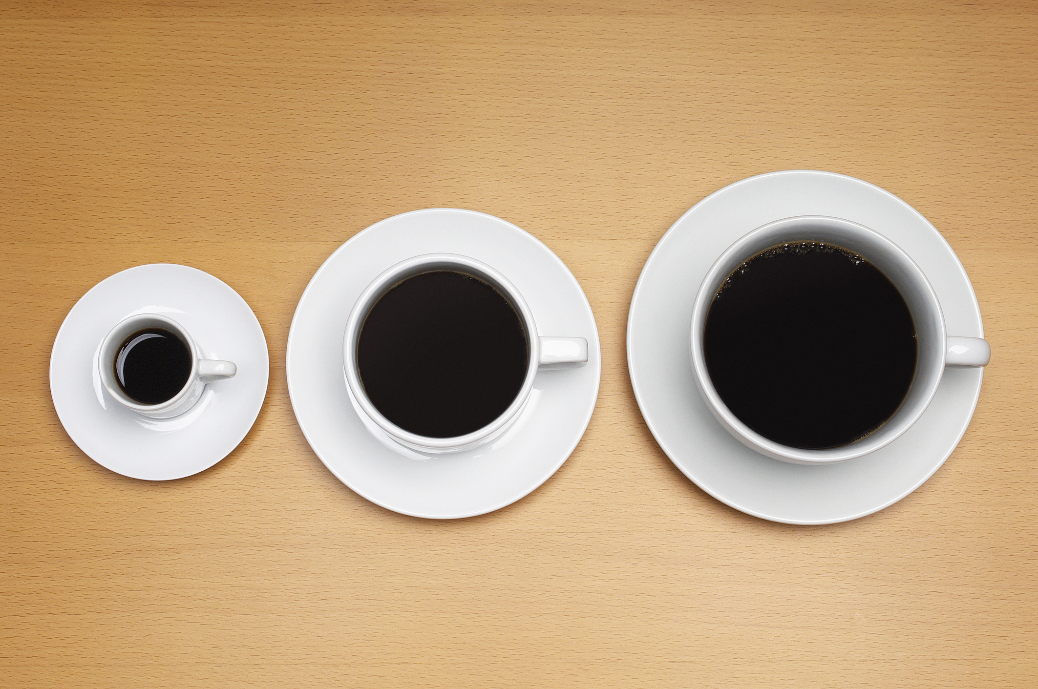 Three coffee cups of various sizes