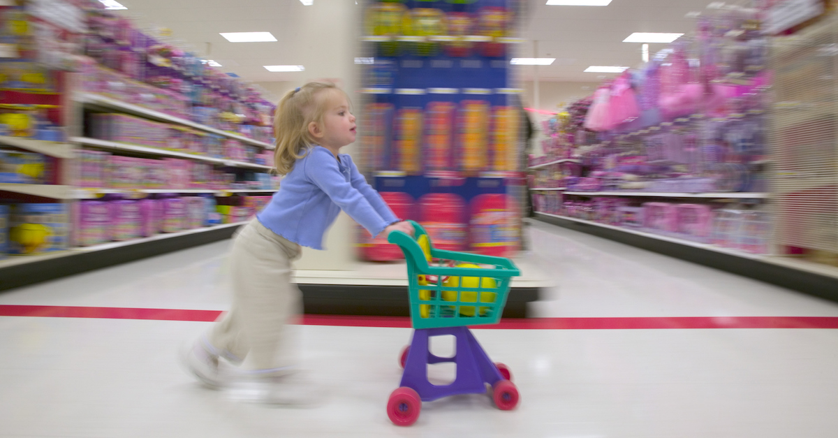 Side profile of a girl pushing a shopping cart in a supermarket