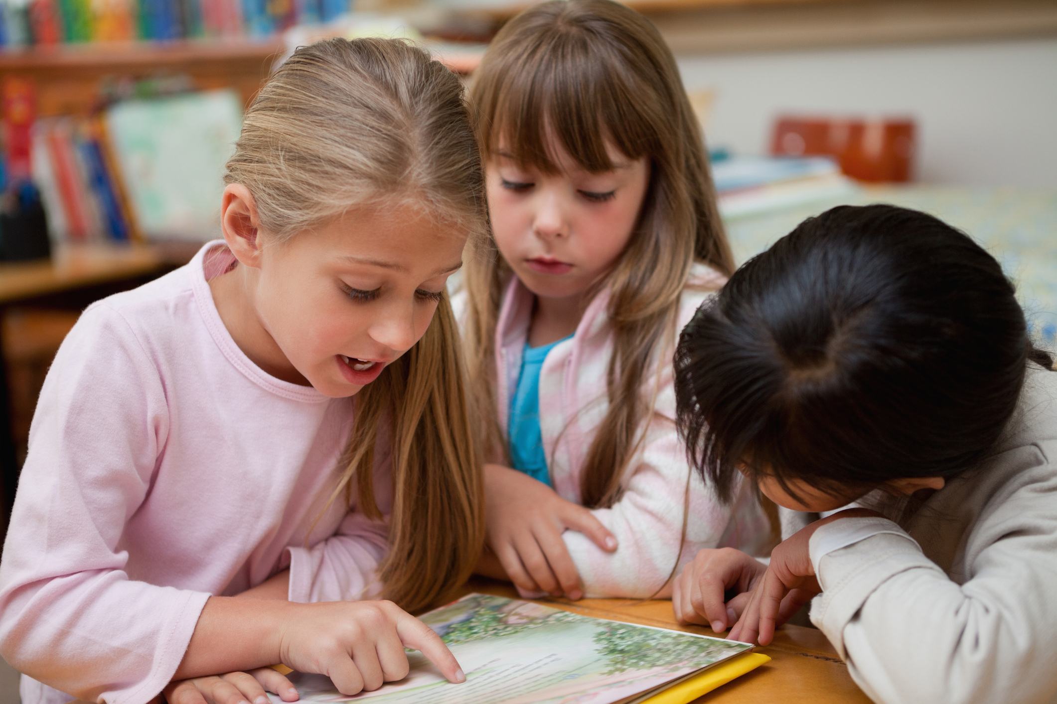 Schoolgirls reading a fairy tale together