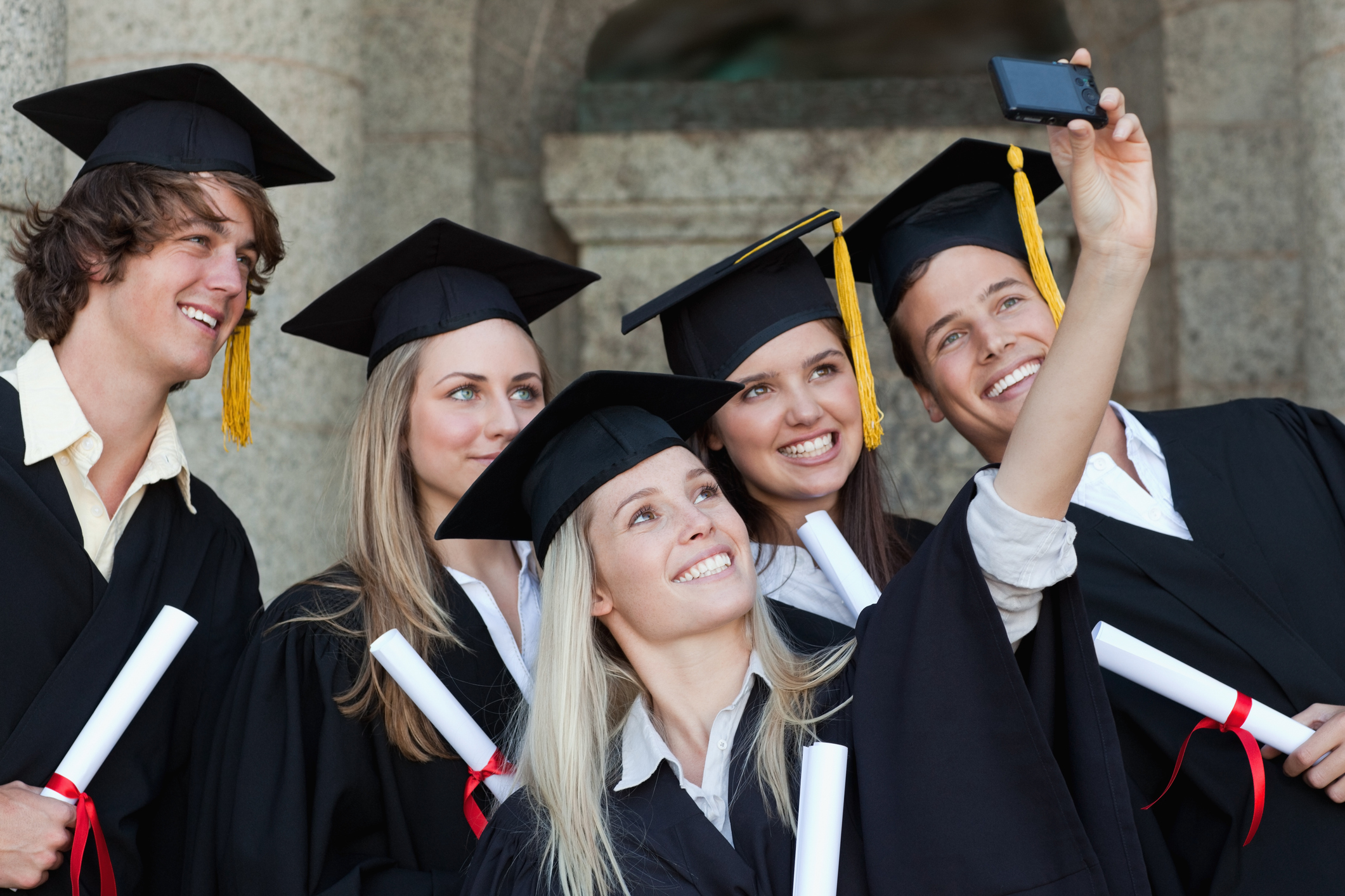 Close-up of five graduates taking a picture of themselves