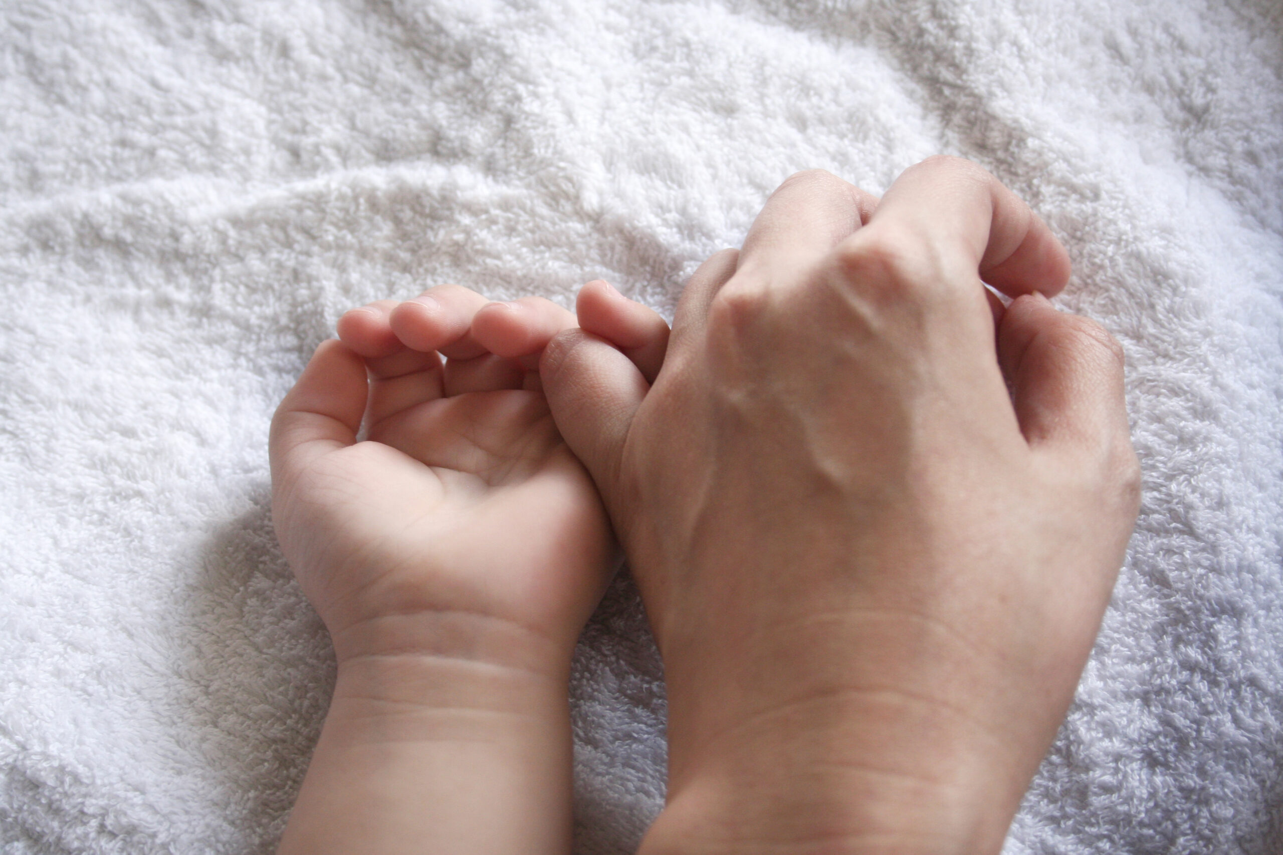 Hands of mother & kid