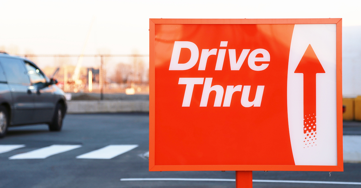 Red and white Drive Thru street sign