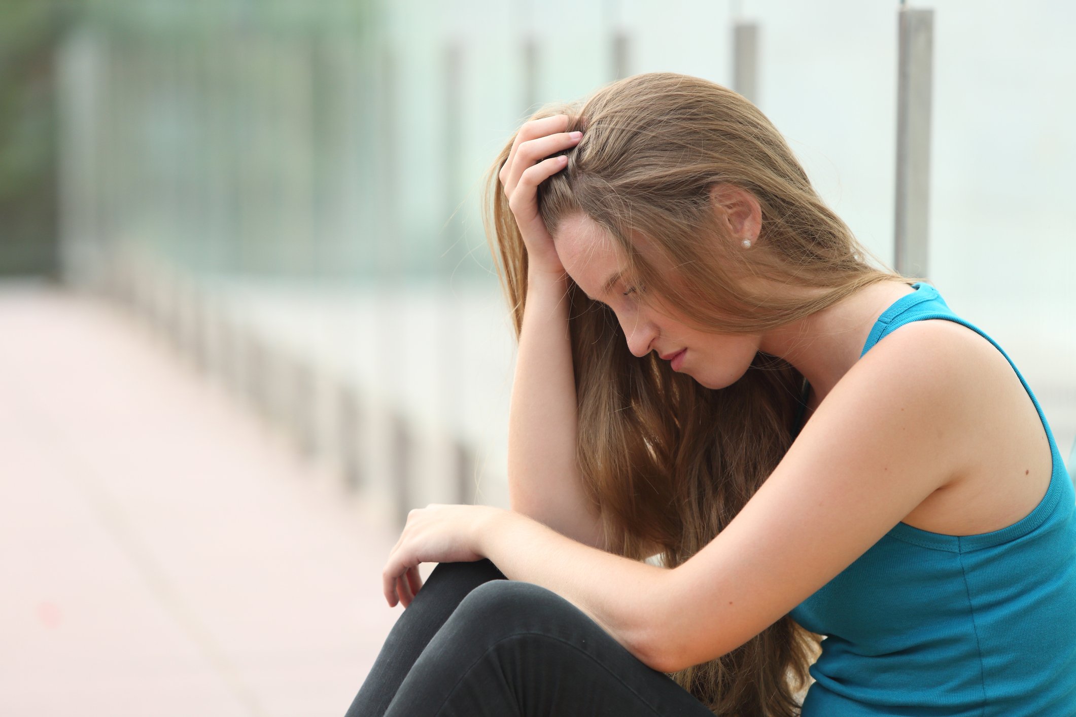 Teenager girl sitting outdoor depressed Teenager girl sitting outdoor depressed