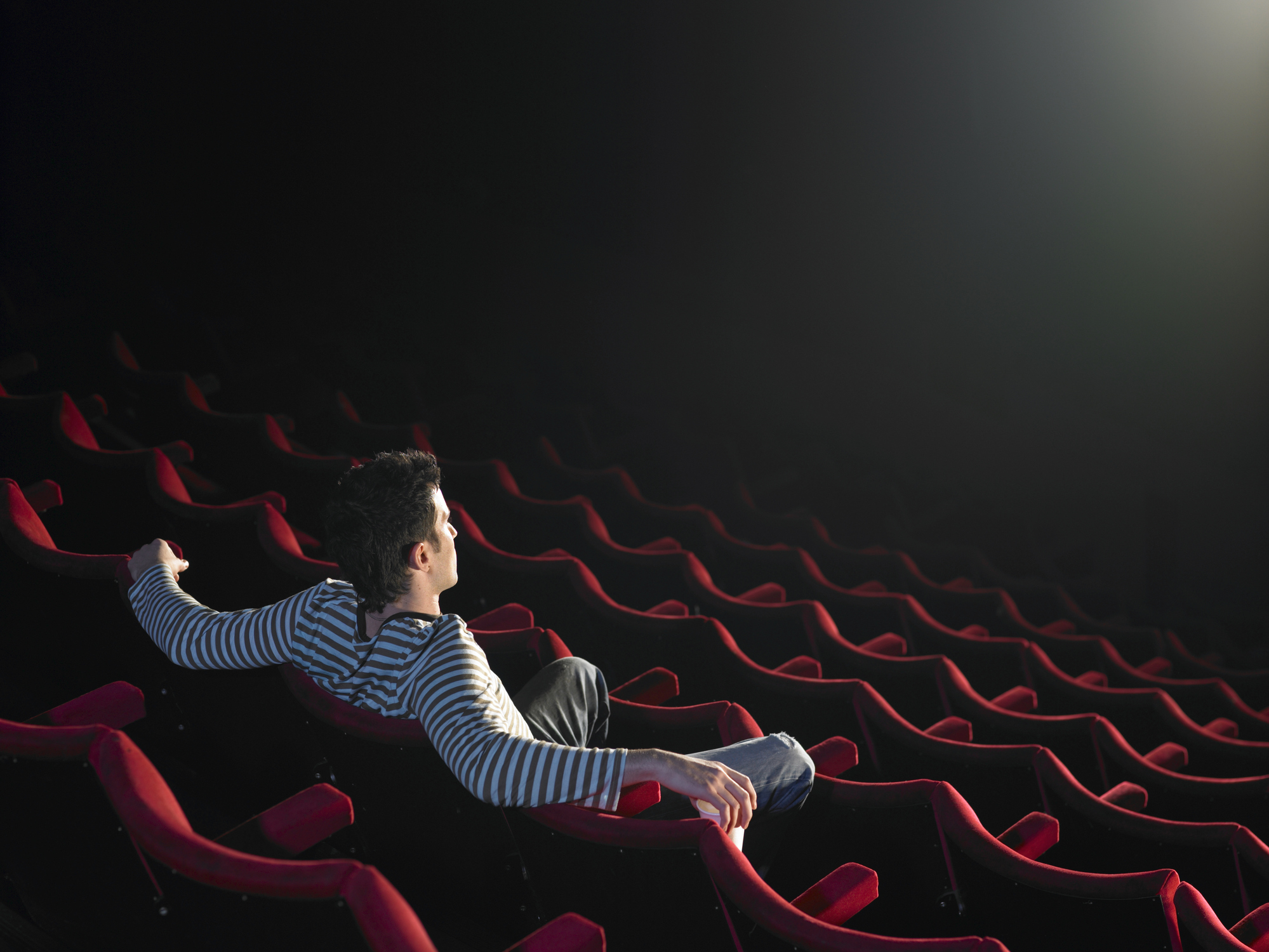 Man sitting in empty cinema