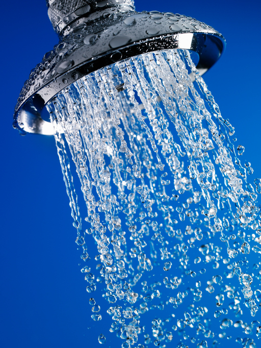 Close up of water flowing from chrome shower head