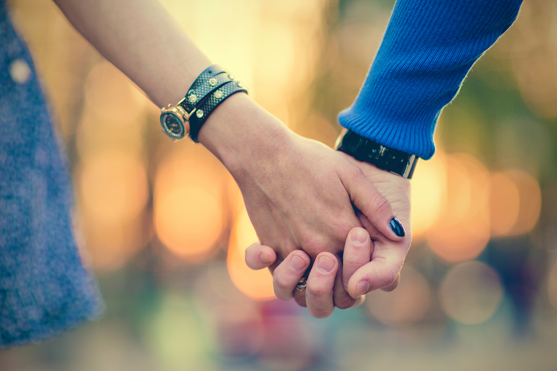 couple holding hands outdoors